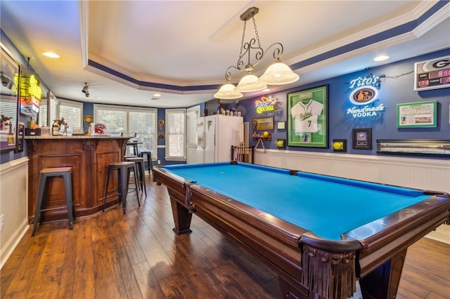 recreation room featuring a tray ceiling, a wainscoted wall, crown molding, billiards, and hardwood / wood-style floors