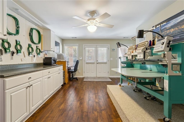 interior space featuring dark wood-type flooring, ceiling fan, and baseboards