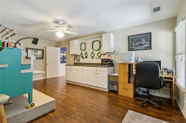 office featuring baseboards, ceiling fan, visible vents, and dark wood-type flooring