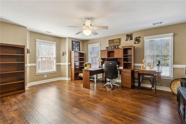 office area featuring hardwood / wood-style floors, a ceiling fan, visible vents, and baseboards