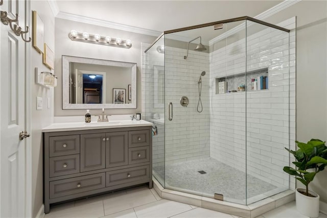 full bathroom with a stall shower, tile patterned flooring, crown molding, and vanity