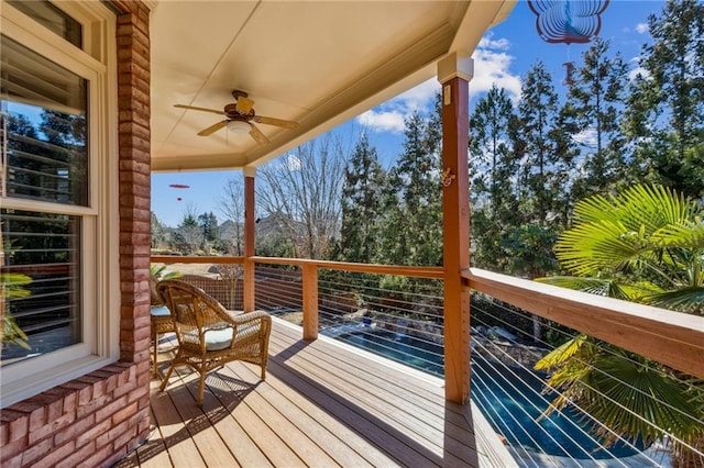 wooden deck featuring ceiling fan