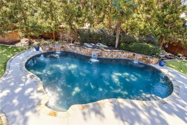 view of swimming pool featuring fence