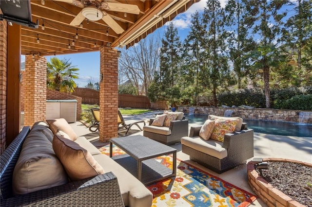 view of patio featuring ceiling fan, a fenced backyard, and an outdoor living space