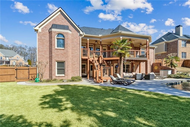 back of house with brick siding, ceiling fan, stairway, and a patio