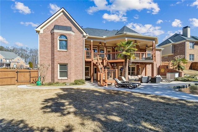 back of house with a patio area, ceiling fan, stairway, and brick siding