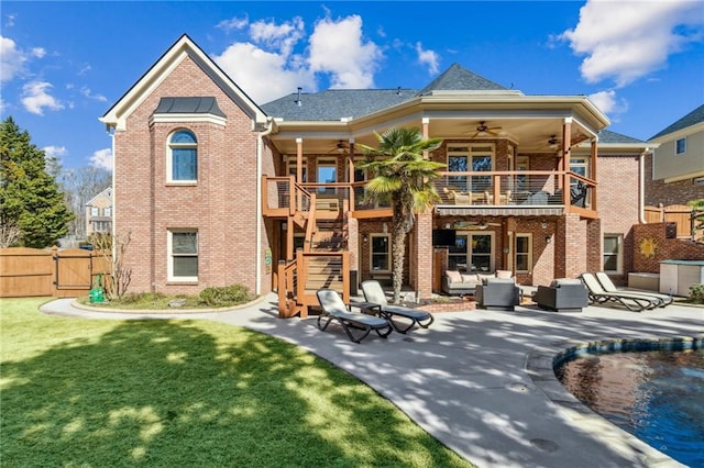 rear view of property with a patio area, brick siding, and stairs