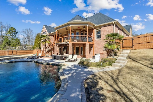 back of house with a patio, a fenced backyard, brick siding, a ceiling fan, and a gate