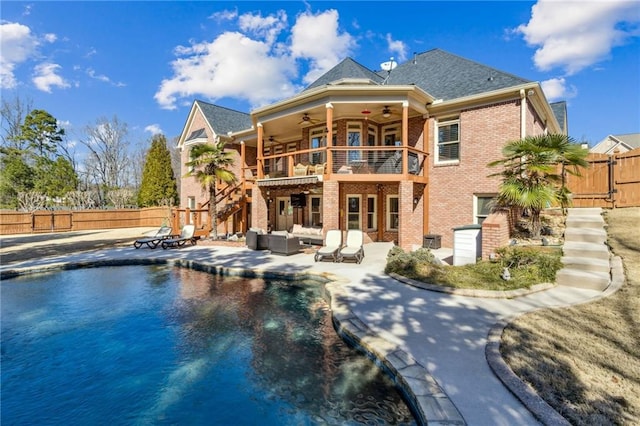 back of house with a ceiling fan, a patio area, brick siding, and fence