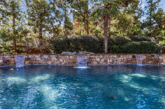 view of swimming pool featuring a fenced in pool