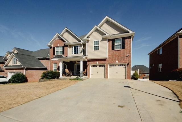 craftsman-style house with an attached garage, covered porch, driveway, and brick siding