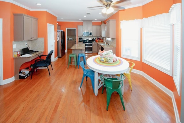 dining room featuring recessed lighting, a ceiling fan, baseboards, light wood-style floors, and crown molding