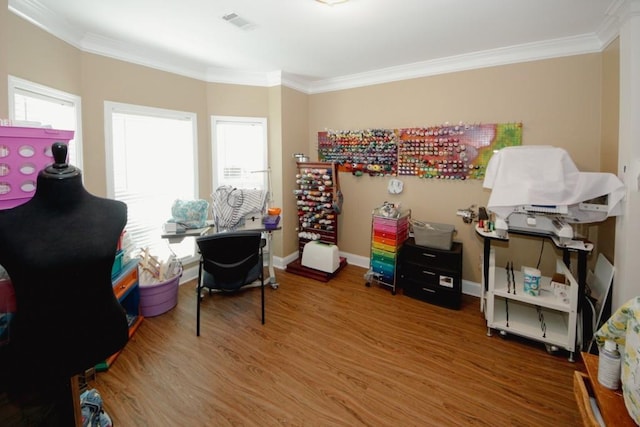 interior space featuring wood finished floors, a wealth of natural light, and crown molding