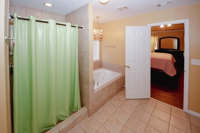 bathroom with tile patterned flooring, visible vents, connected bathroom, and a bath