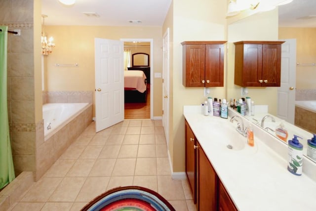 ensuite bathroom featuring visible vents, connected bathroom, a garden tub, tile patterned flooring, and vanity