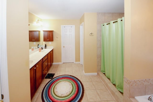 full bath featuring double vanity, baseboards, tile patterned floors, curtained shower, and a sink