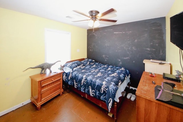 bedroom with ceiling fan and baseboards