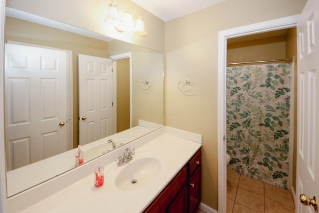 full bath with curtained shower, vanity, and tile patterned floors