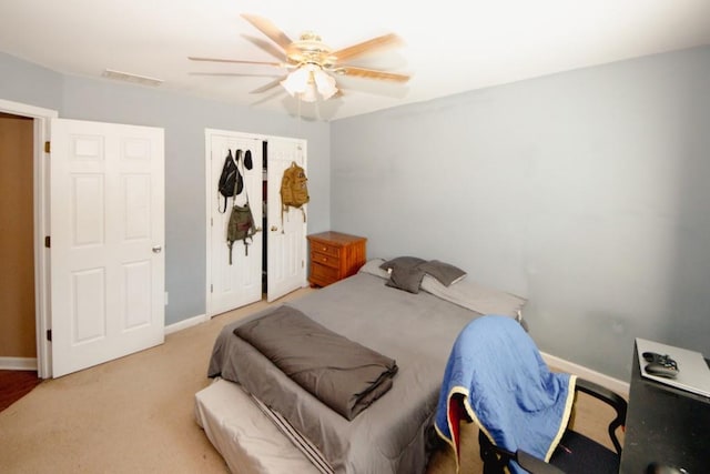 bedroom with carpet, visible vents, and baseboards