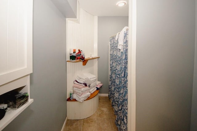 full bath with tile patterned flooring, baseboards, and curtained shower