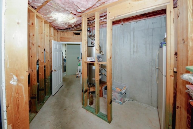 unfinished below grade area featuring freestanding refrigerator