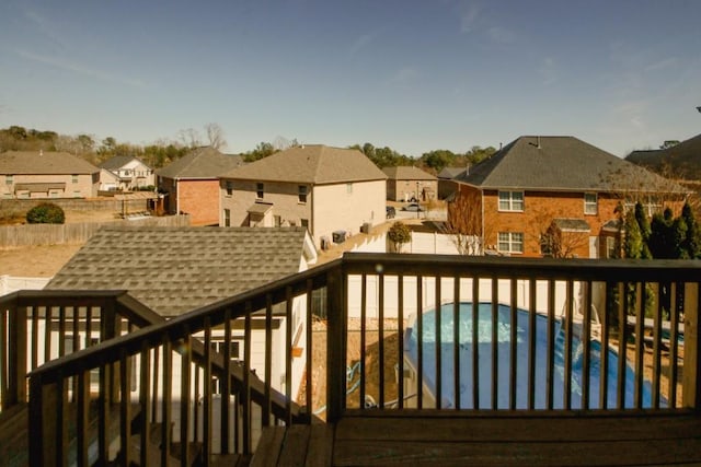 deck with a fenced in pool and a residential view