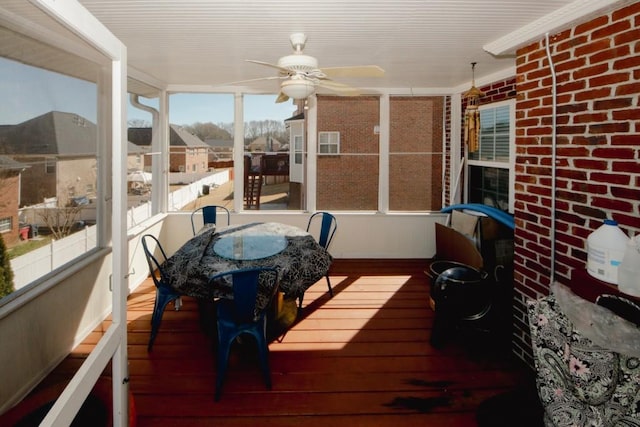 sunroom / solarium featuring ceiling fan