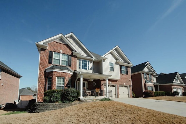 craftsman house with a garage, driveway, brick siding, and a porch