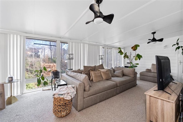 carpeted living area with ceiling fan