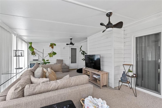 carpeted living room featuring a ceiling fan