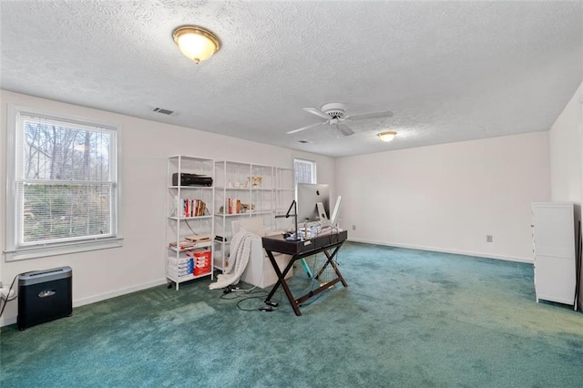 office with a textured ceiling, carpet flooring, visible vents, and baseboards