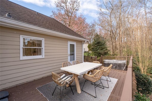 wooden terrace featuring outdoor dining area and a hot tub