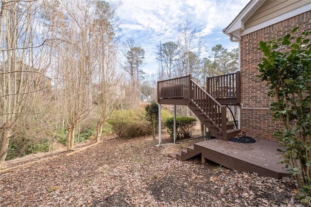 view of yard featuring stairway and a wooden deck