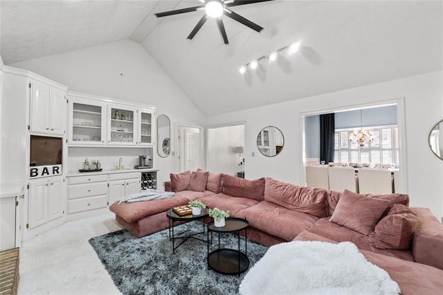 living area featuring ceiling fan with notable chandelier, high vaulted ceiling, and light carpet