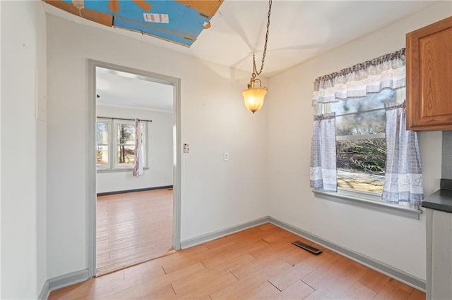 unfurnished dining area featuring light hardwood / wood-style flooring