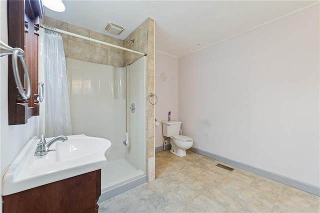 bathroom featuring toilet, vanity, and a shower with curtain