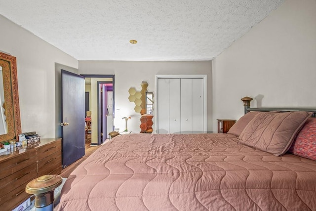 bedroom with a textured ceiling and a closet