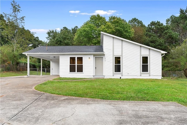 view of front facade with a front yard and a carport