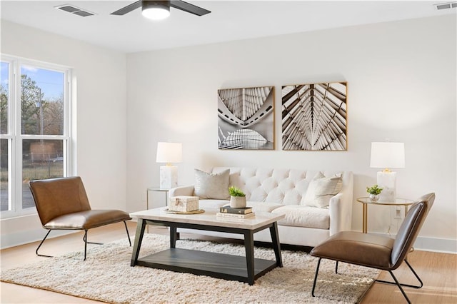 living area featuring hardwood / wood-style flooring and ceiling fan