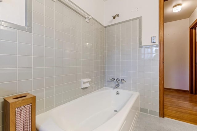 bathroom featuring tile walls and shower / bathing tub combination