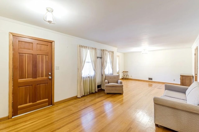 living room with hardwood / wood-style flooring and ornamental molding