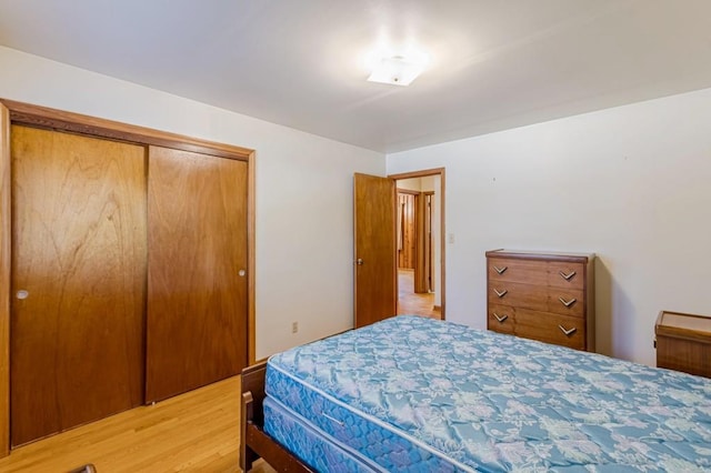 bedroom with a closet and light wood-type flooring