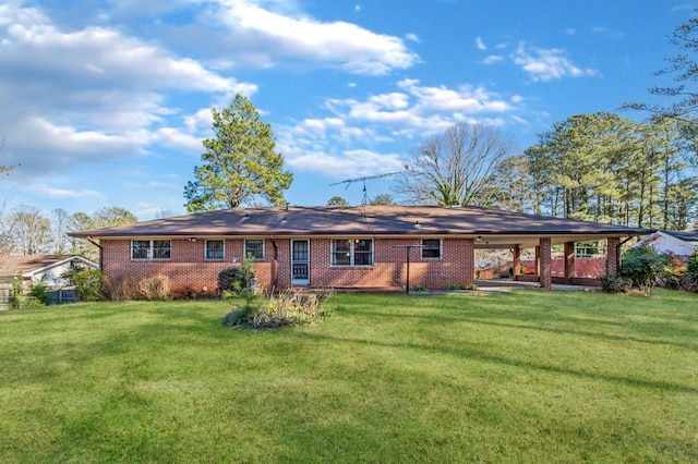 rear view of house featuring a lawn