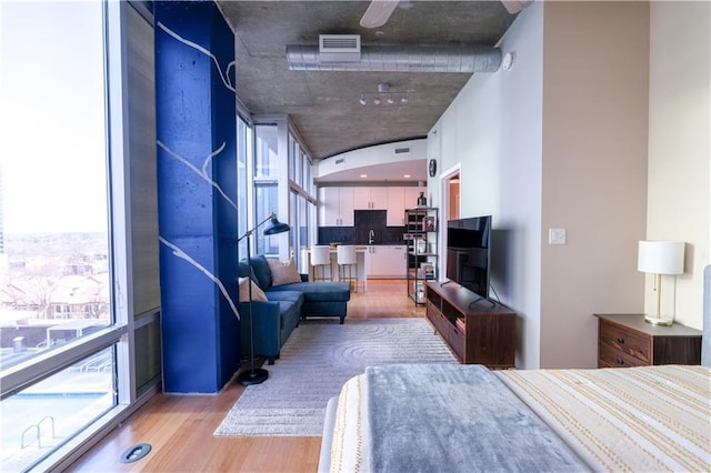 bedroom featuring visible vents and light wood-style floors