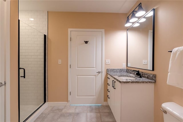 bathroom featuring baseboards, toilet, a stall shower, tile patterned floors, and vanity