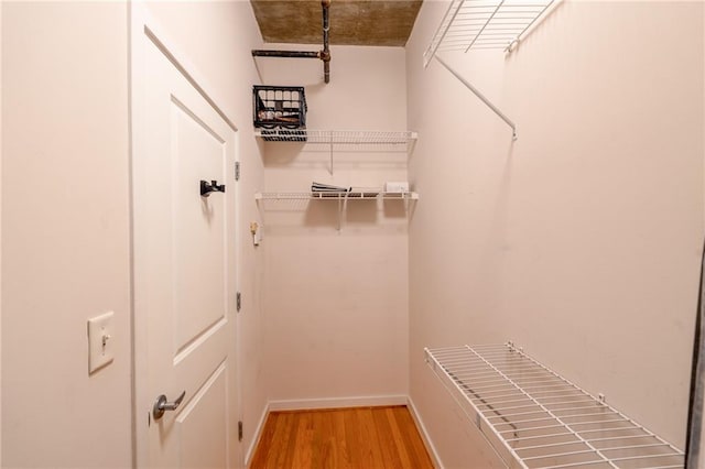 walk in closet featuring light wood-style flooring