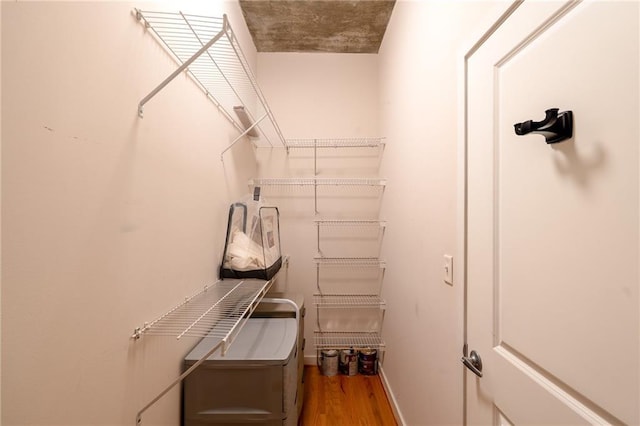 washroom with baseboards and wood finished floors