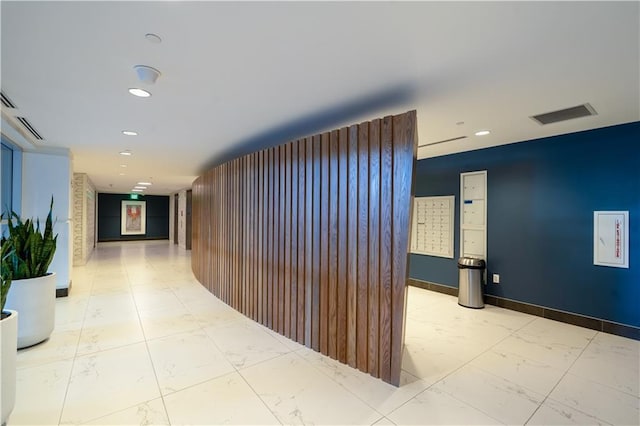 hallway with recessed lighting, visible vents, and marble finish floor