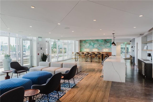 living room featuring a wall of windows, plenty of natural light, and recessed lighting