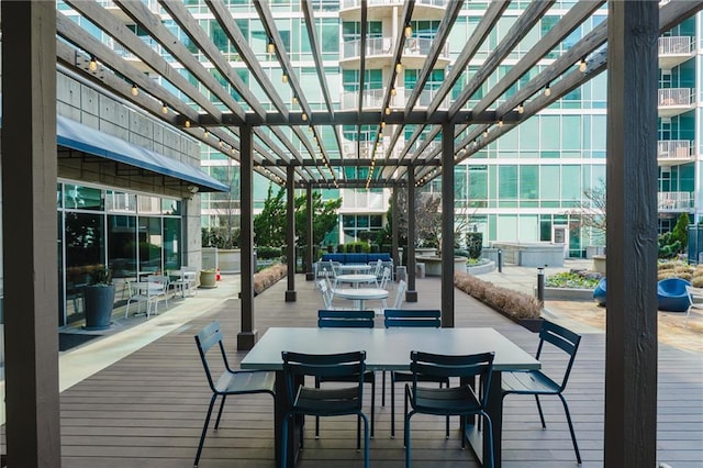 wooden deck with outdoor dining space and a pergola